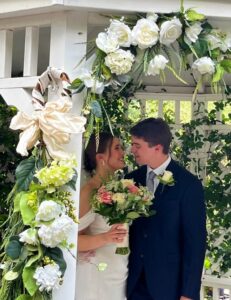 Bride and groom under gazebo