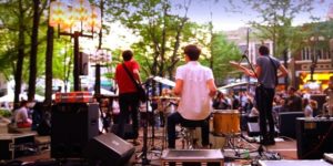 Musicians playing on a stage on Main St.