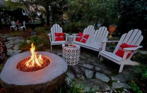 Crackling fire near seating area with wine and cheese tray.