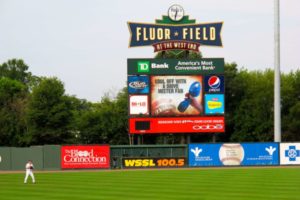 Baseball field score board with ball player.