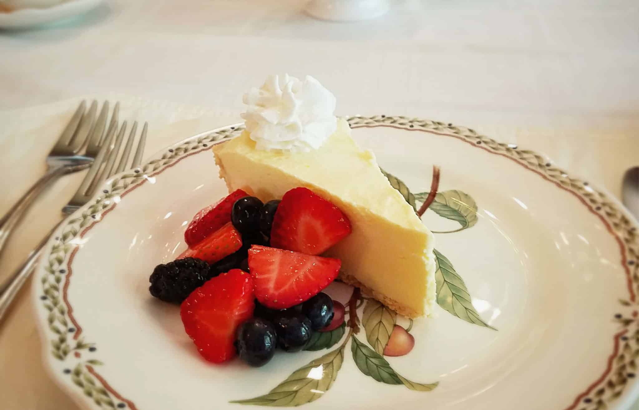 Frozen lemon tart with fresh berries and whipped cream.