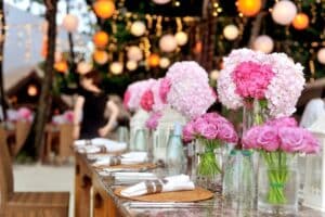 Wedding table set with pink flowers with floating lanterns.