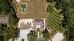 Aerial view of winery with wine glass shaped fountain. 