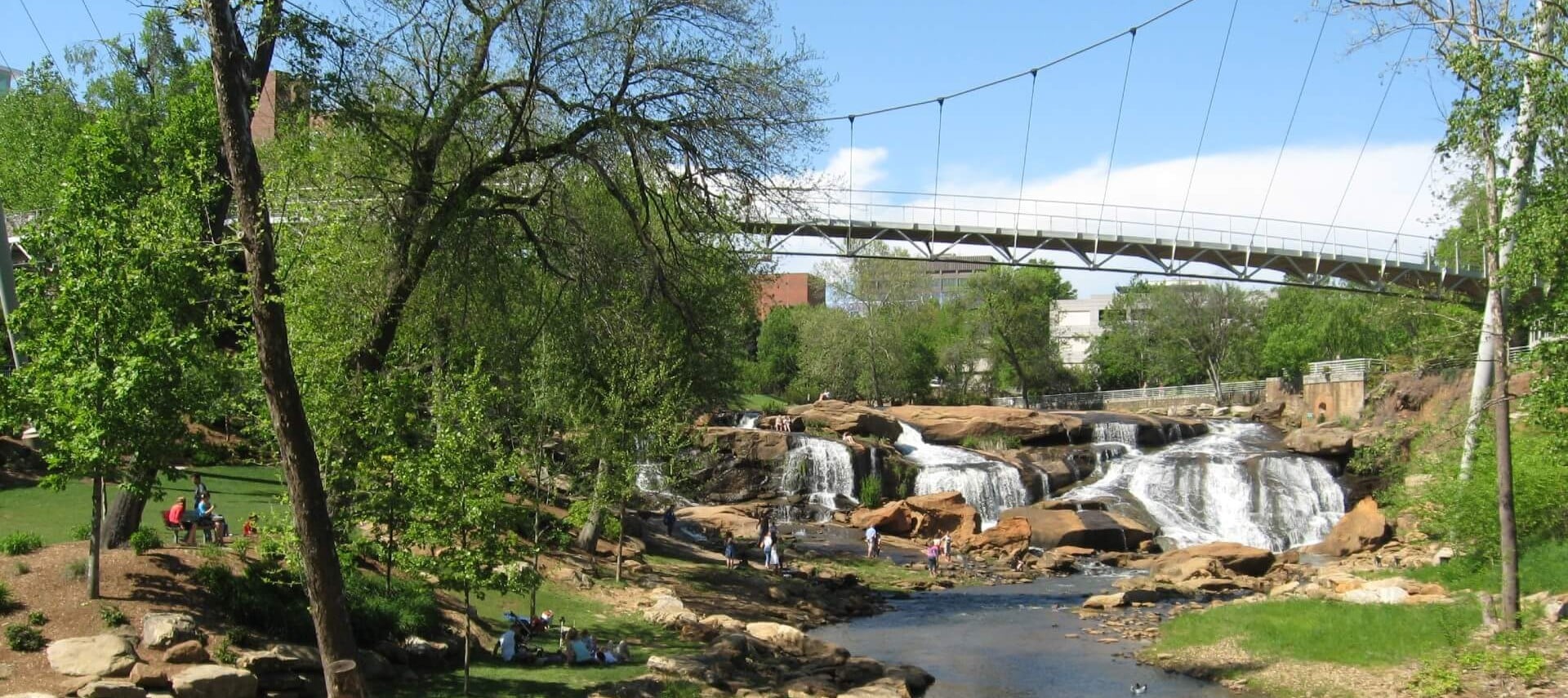 Bridge over waterfall in park