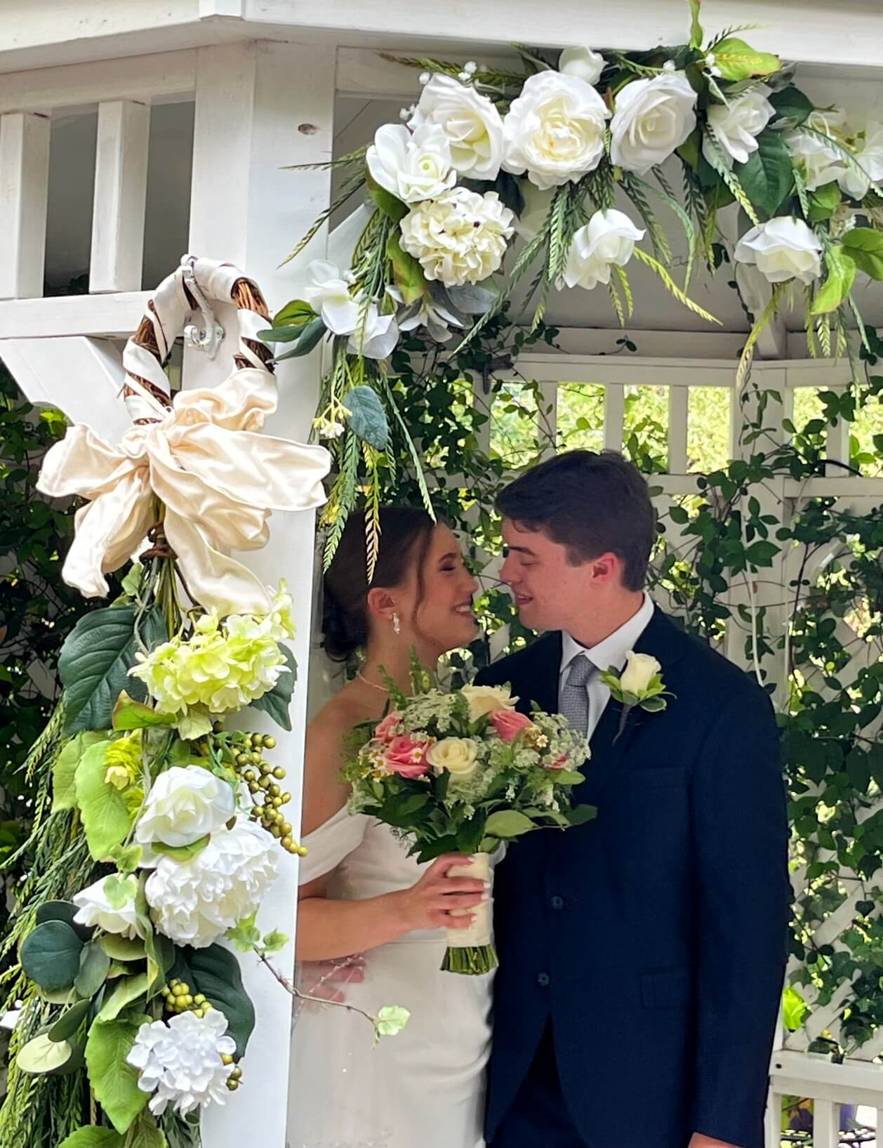 Wedding couple getting married in gazebo.