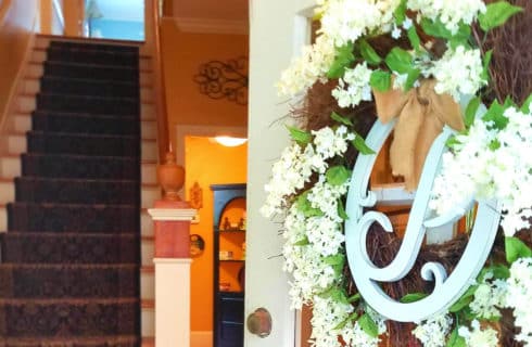 Entryway looking at staircase, with a flowered 