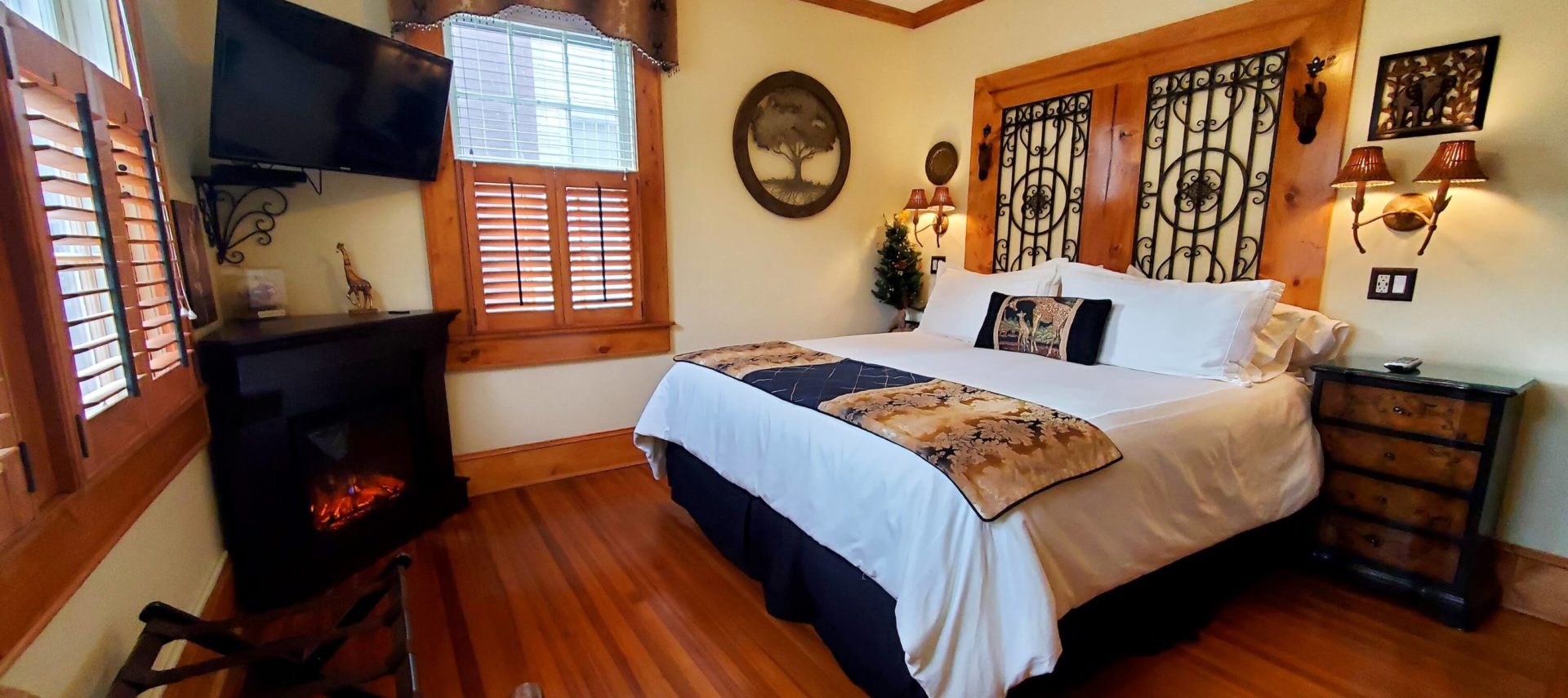 California King bed in downstairs room with fireplace.