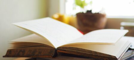 Open book on a table in front of window
