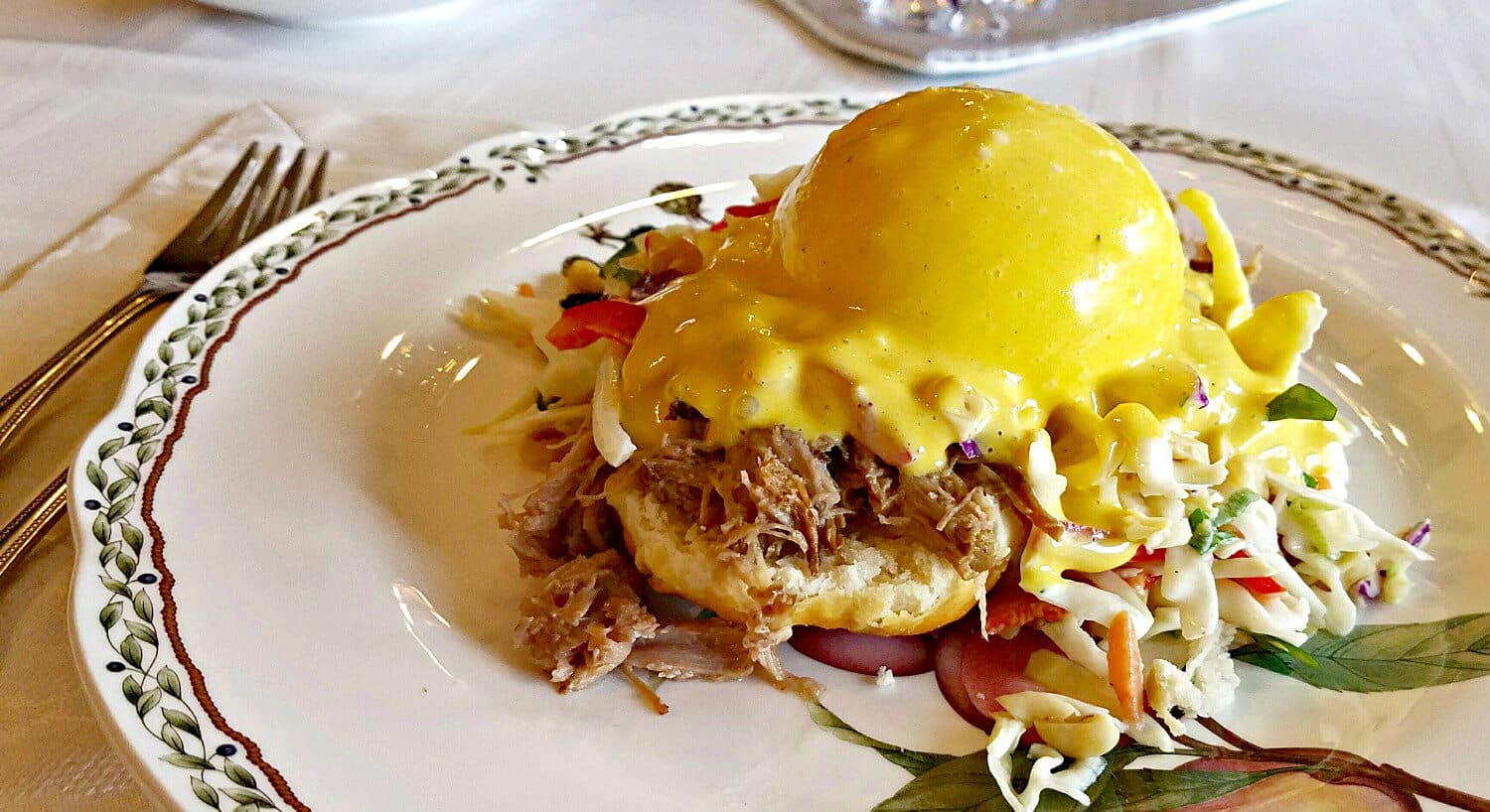 Barbeque Benedict - bbq meat on a biscuit with coleslaw and hollandaise sauce. 