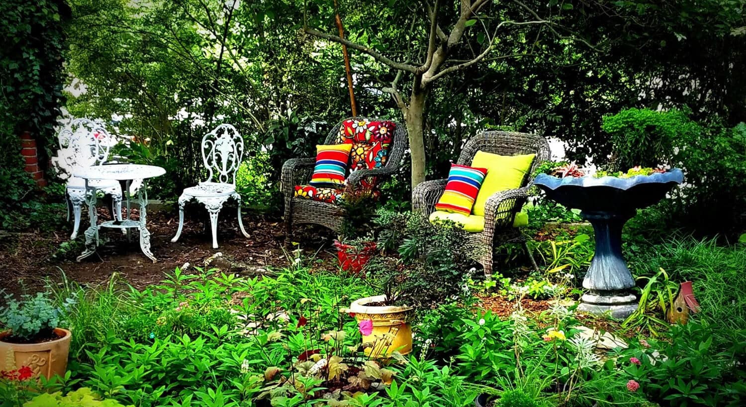 Outdoor seating area with wicker chairs and bright cushions. 