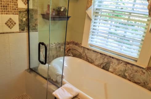 Bathroom with a separate shower and claw-foot tub.