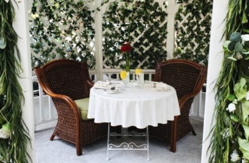 Table for two set outside with ivy background