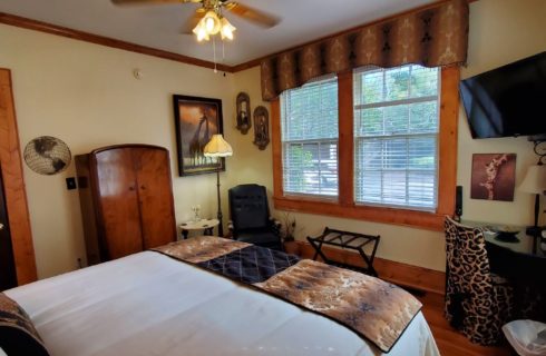 Large bed, armoire, leather chair and windows