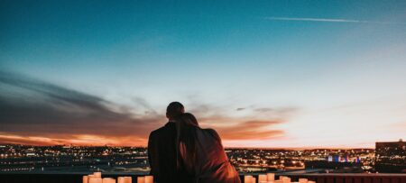 A couple overlooing skyline on romantic evening