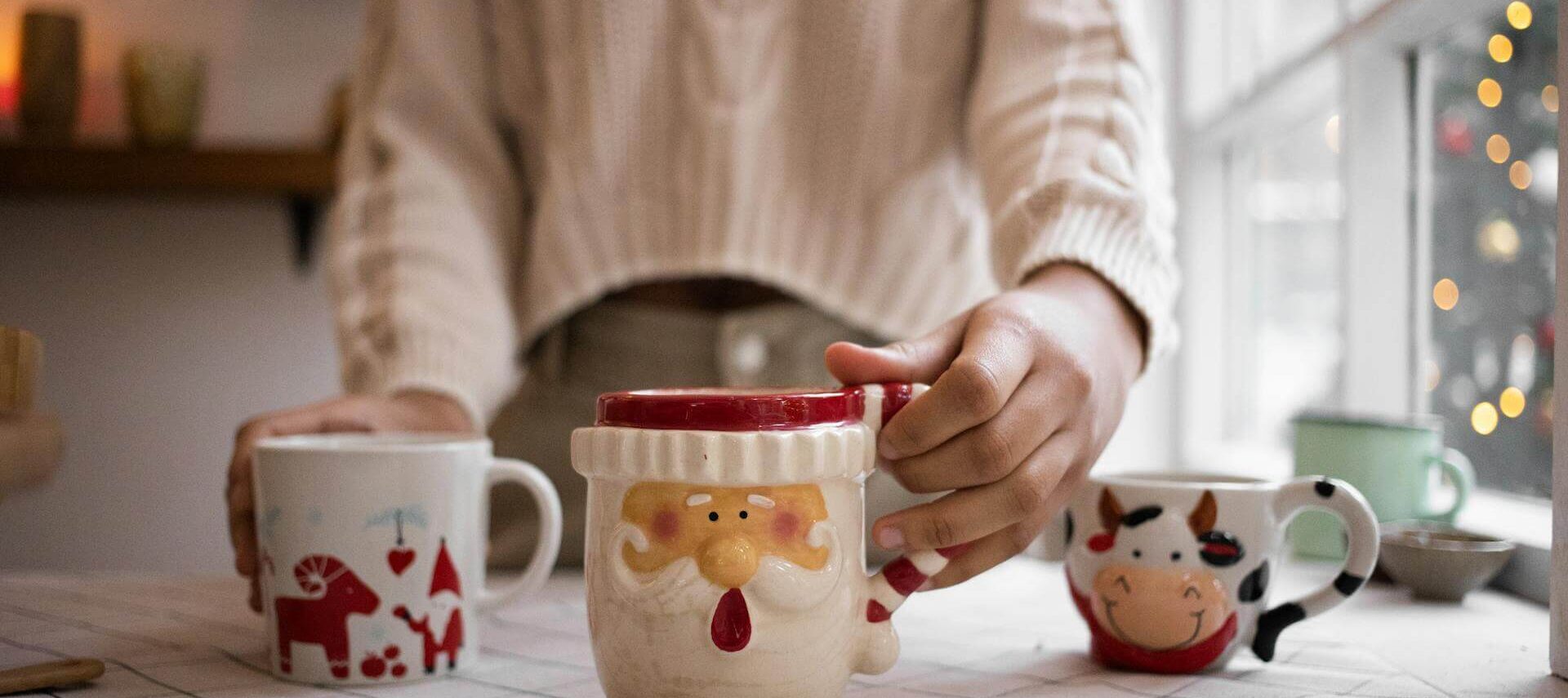 Photo by KATRIN BOLOVTSOVA: https://www.pexels.com/photo/person-holding-santa-claus-ceramic-mug-6606589/