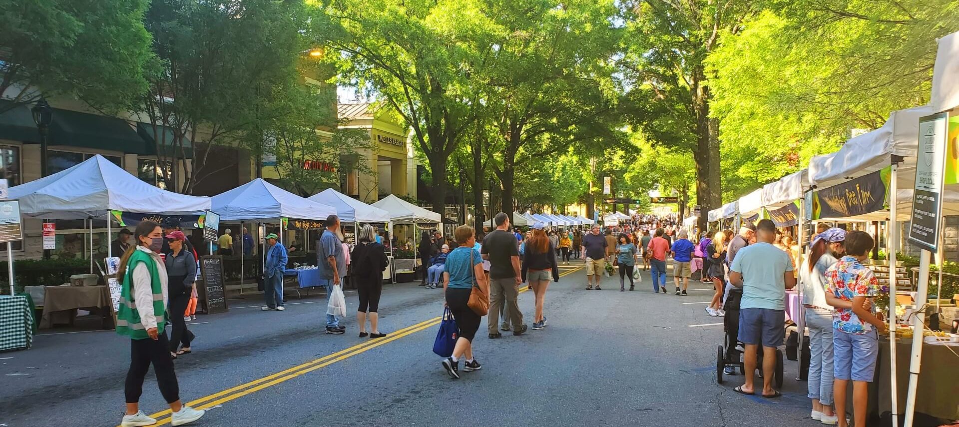 Shaded out door market with people on Main Street