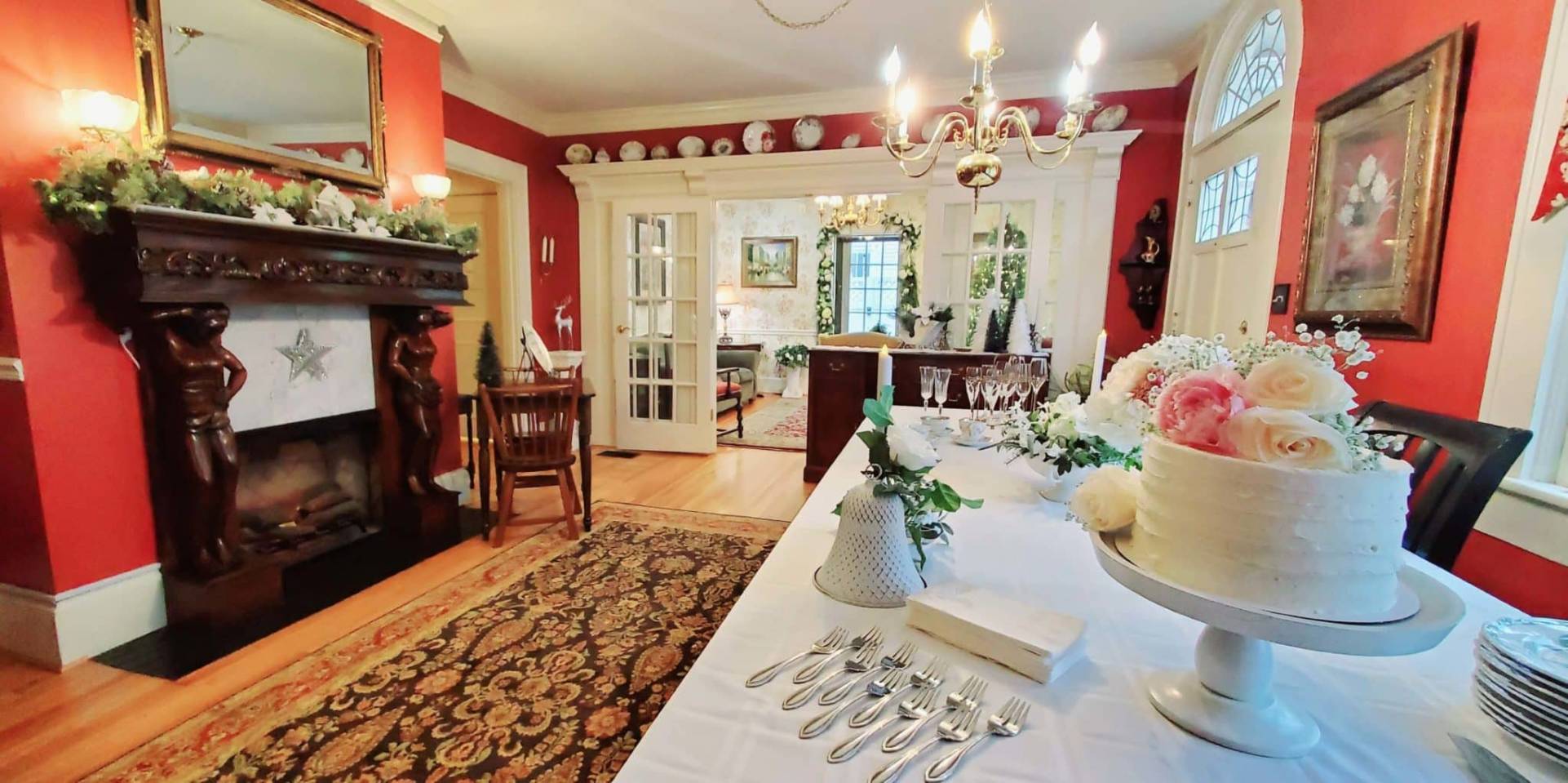 Dining room decorated for wedding with flower topped cake