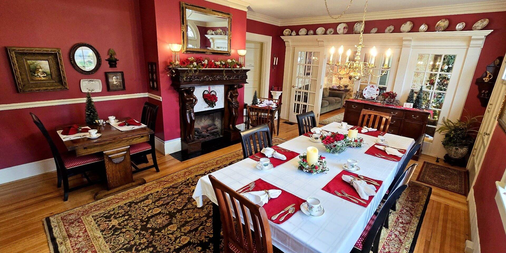 Dining room dressed in red and white for Valentines day with fireplace. 