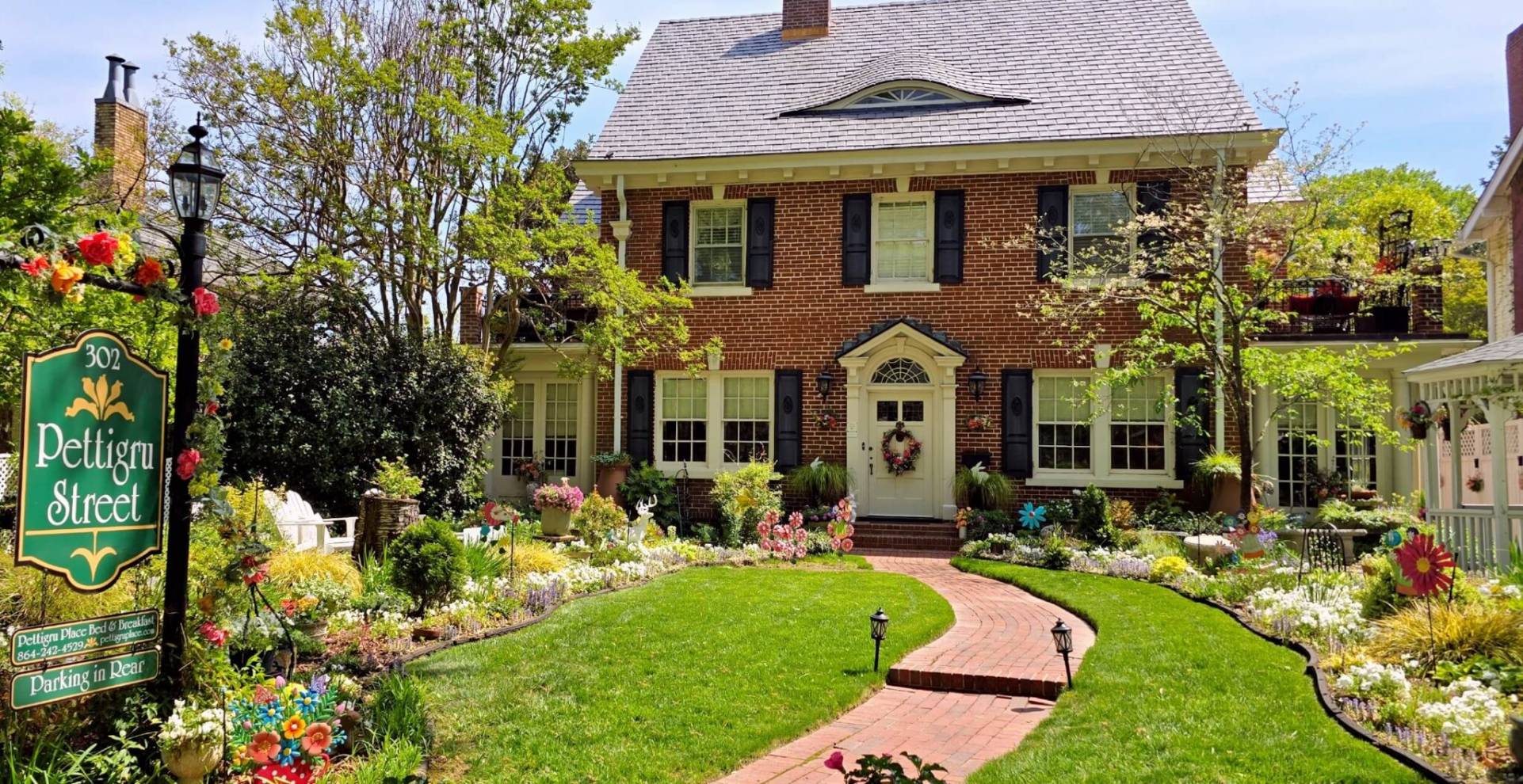 Red Brick house with blooming garden with red brick path
