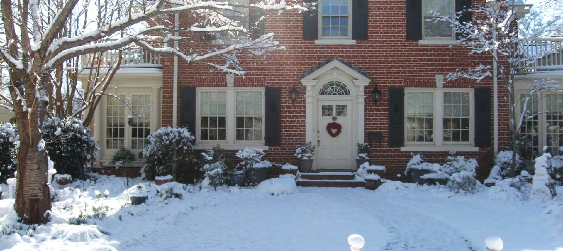 House on a sunny snow covered day