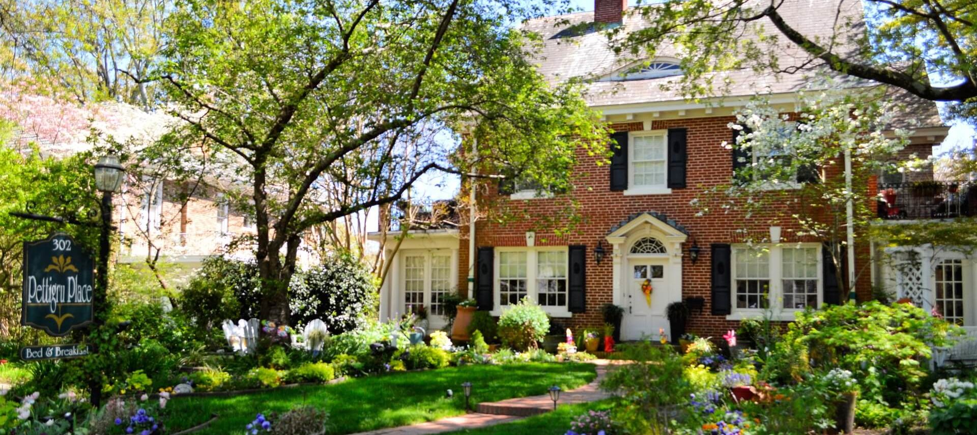 Spring garden in front of red brick house