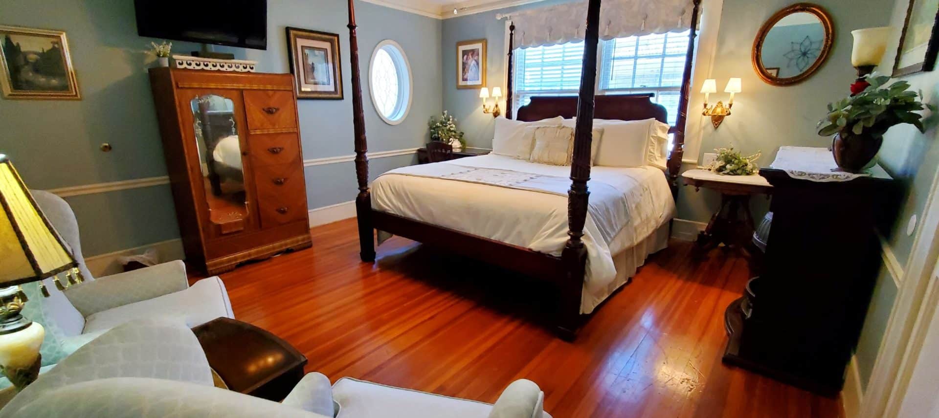 California King bed with antique armoire and flat screen tv