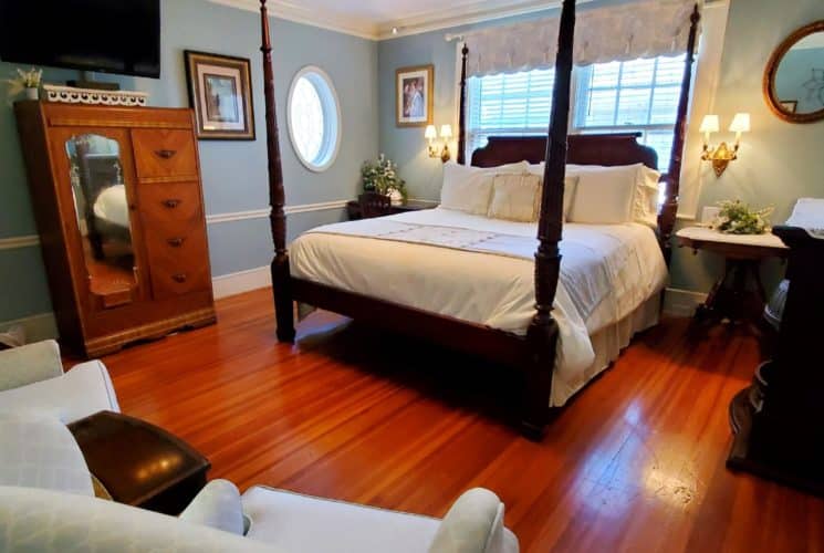 California King bed with antique armoire and flat screen tv